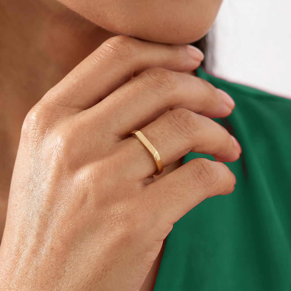 Minimalist gold bar ring on hand