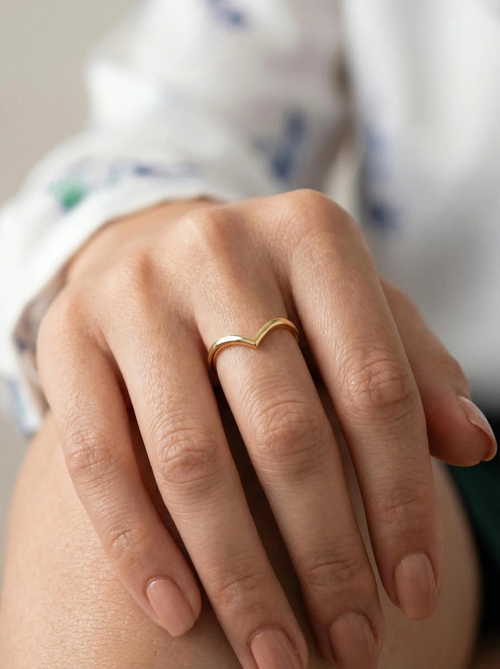Minimal gold wishbone ring on hand