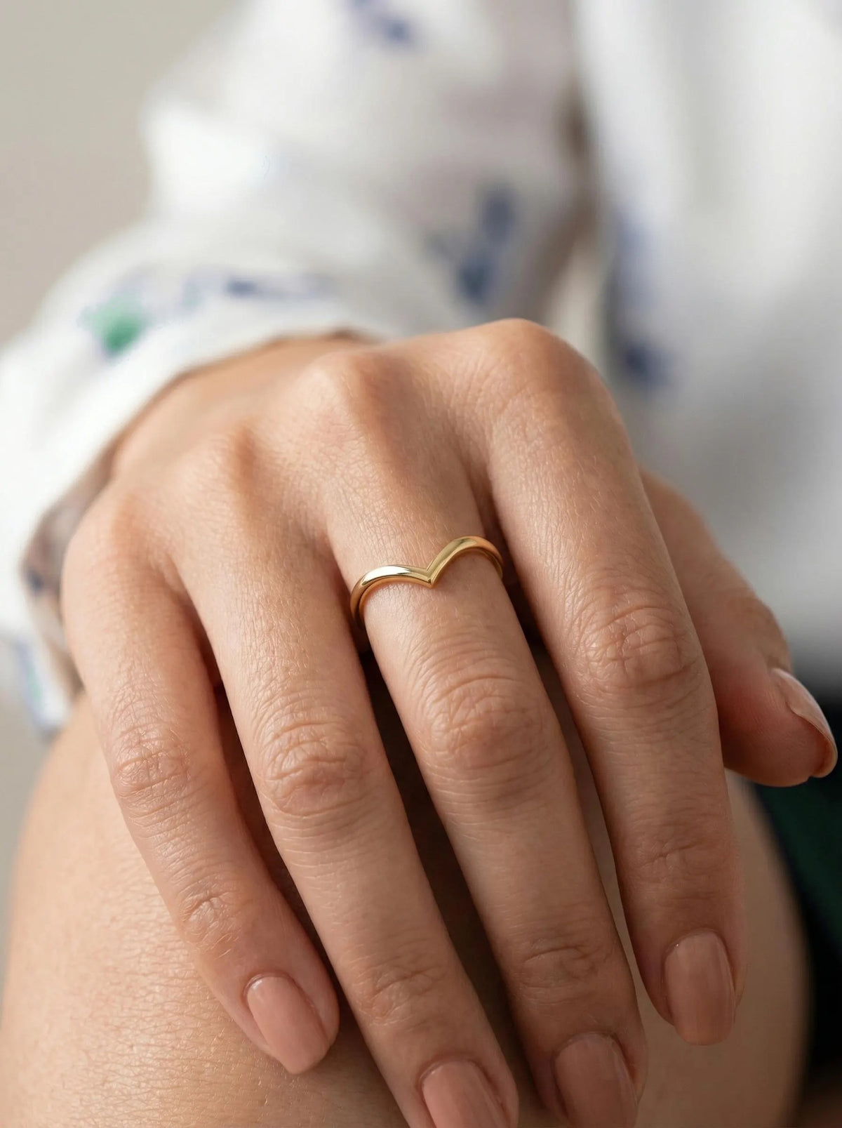 Minimal gold wishbone ring on hand