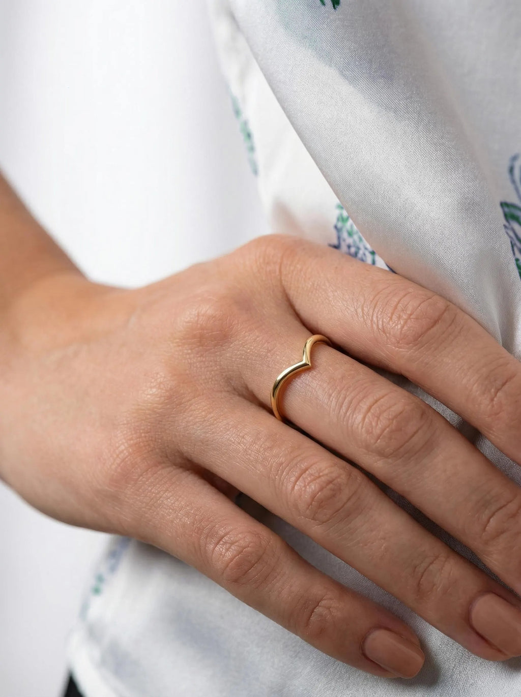Gold chevron stackable ring on hand