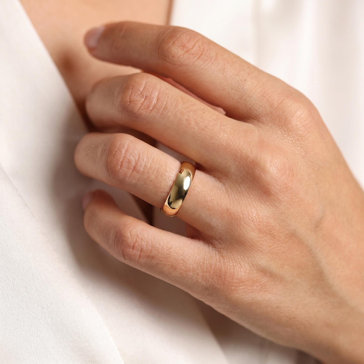 Dome band worn on the ring finger