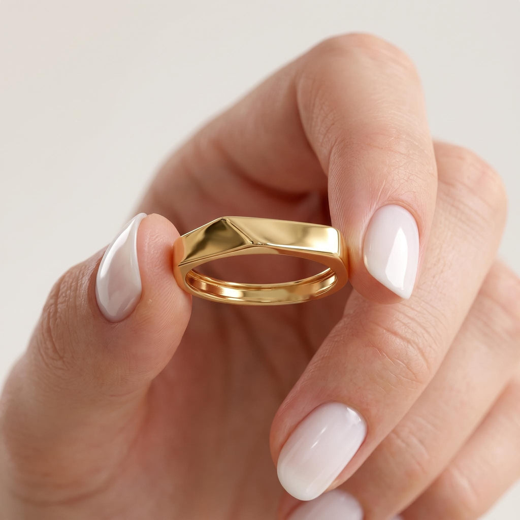 Gold edge ring held between fingers