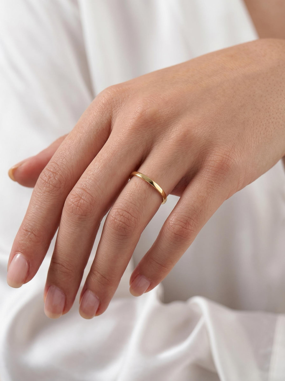 Minimalist gold band on hand