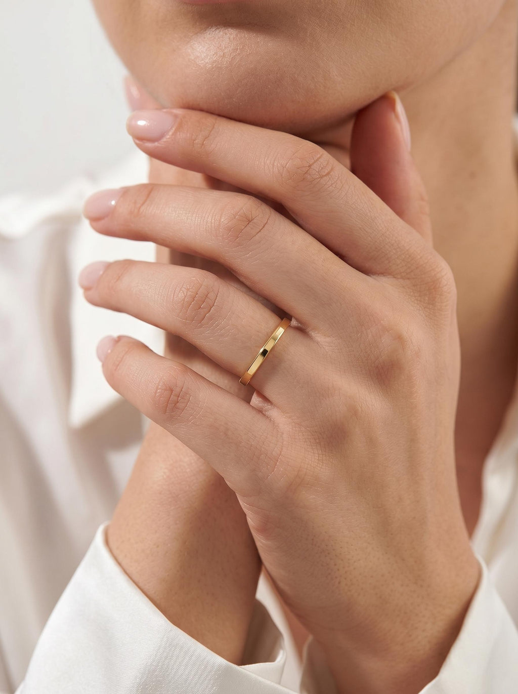 Thin gold stacking ring on hand