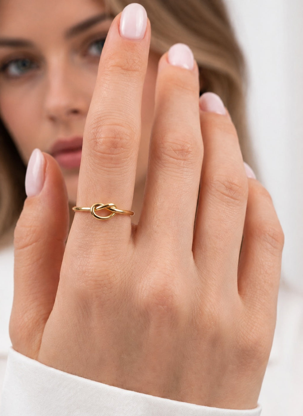 Woman wearing the 14k gold love knot ring