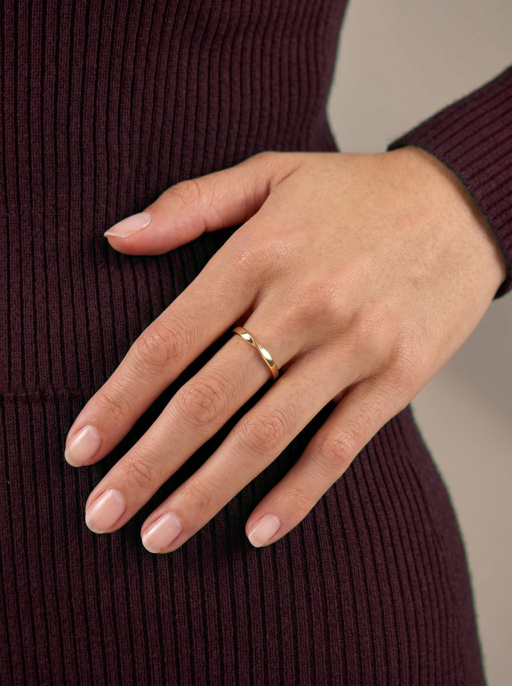 Minimalist twist ring worn on hand