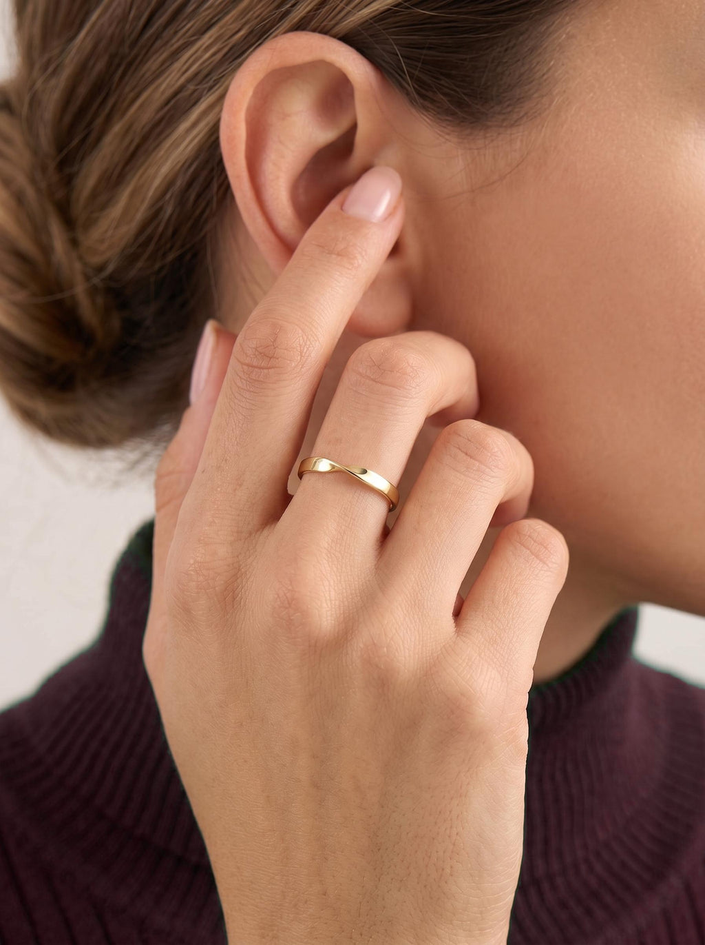 Gold twist band worn on finger