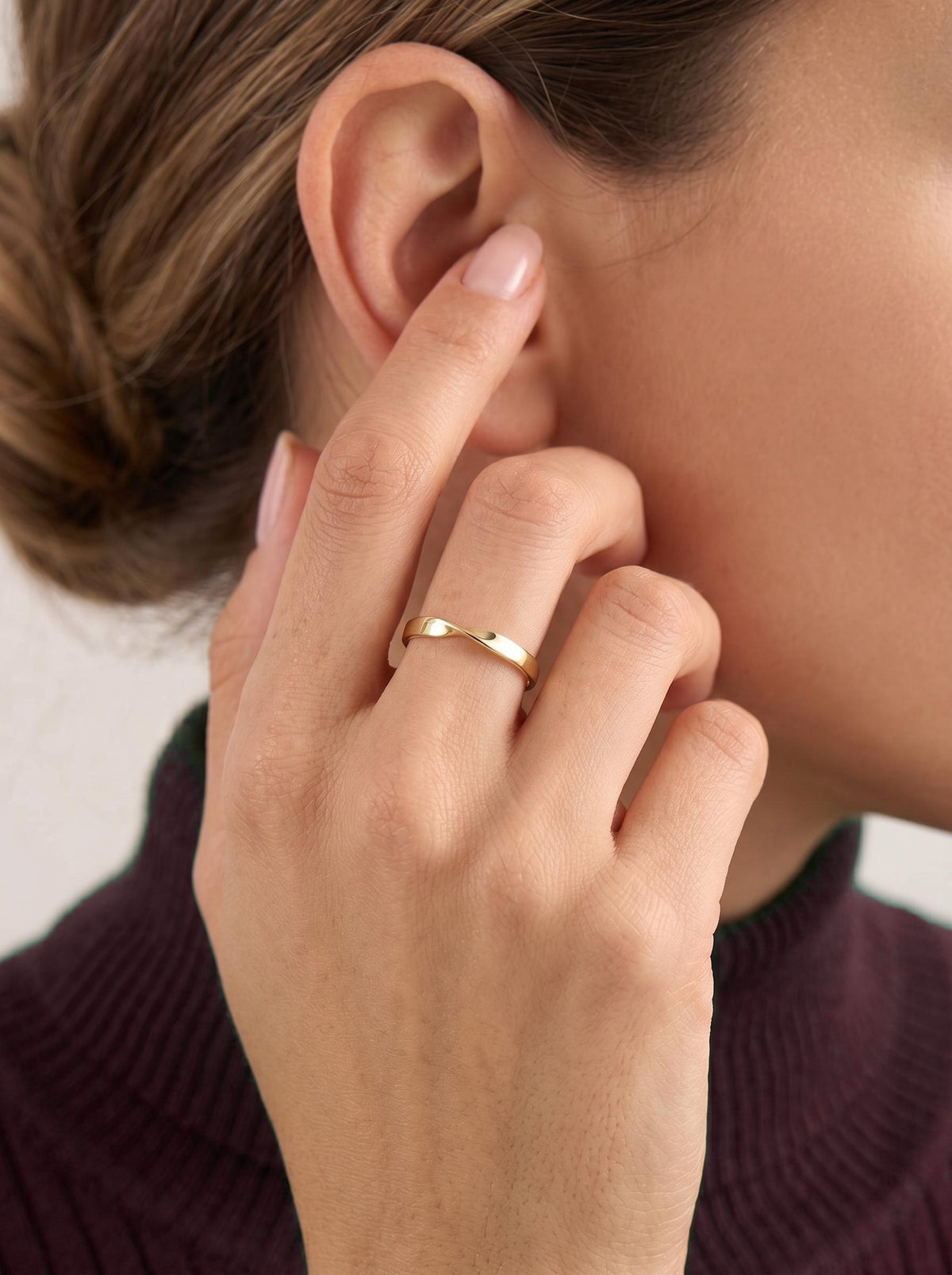 Gold twist band worn on finger