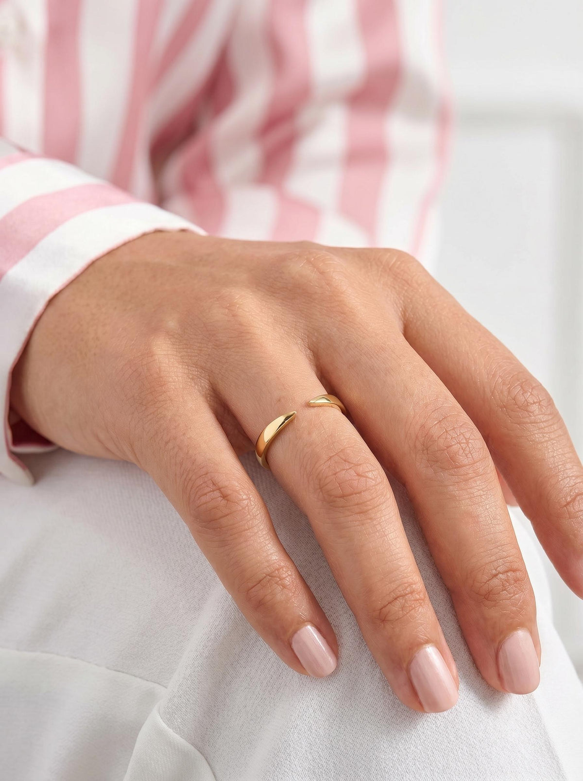 Open cuff ring on a resting hand