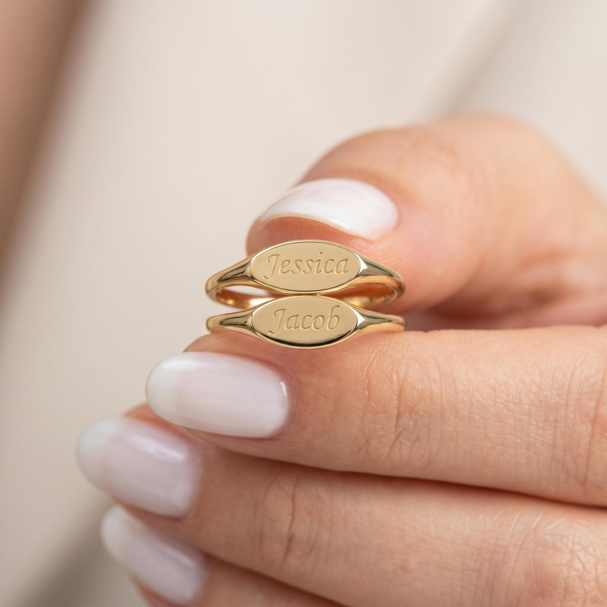 Two engraved oval signet rings stacked