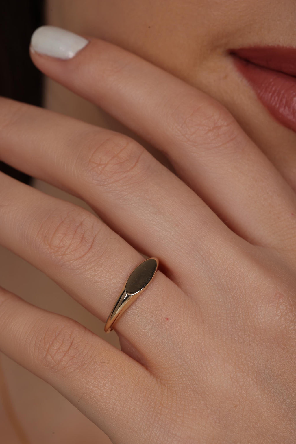 Oval signet ring worn on the finger