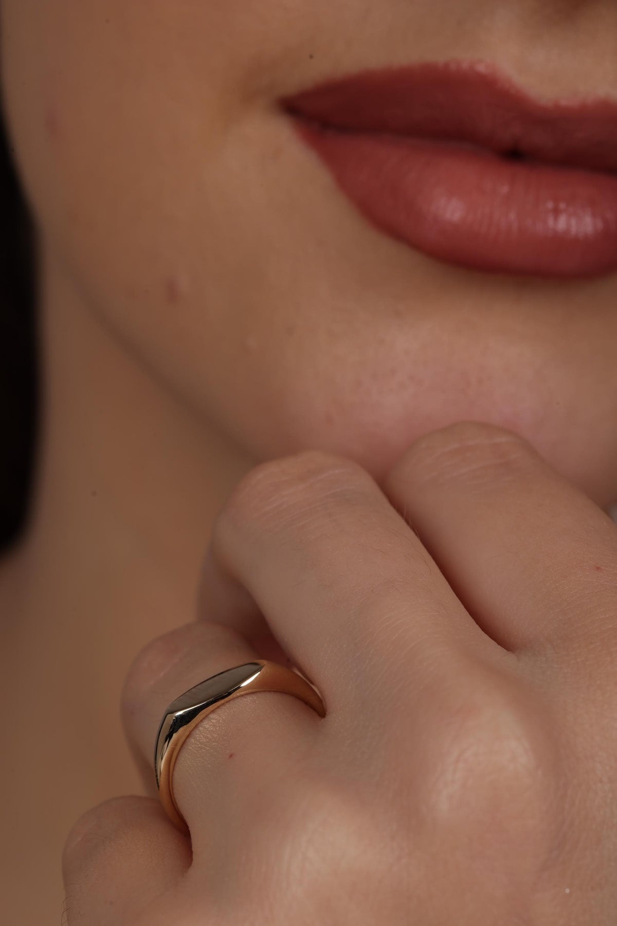Oval signet ring worn as a pinky ring