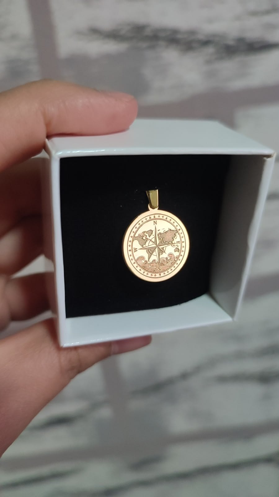 World compass medallion in gold