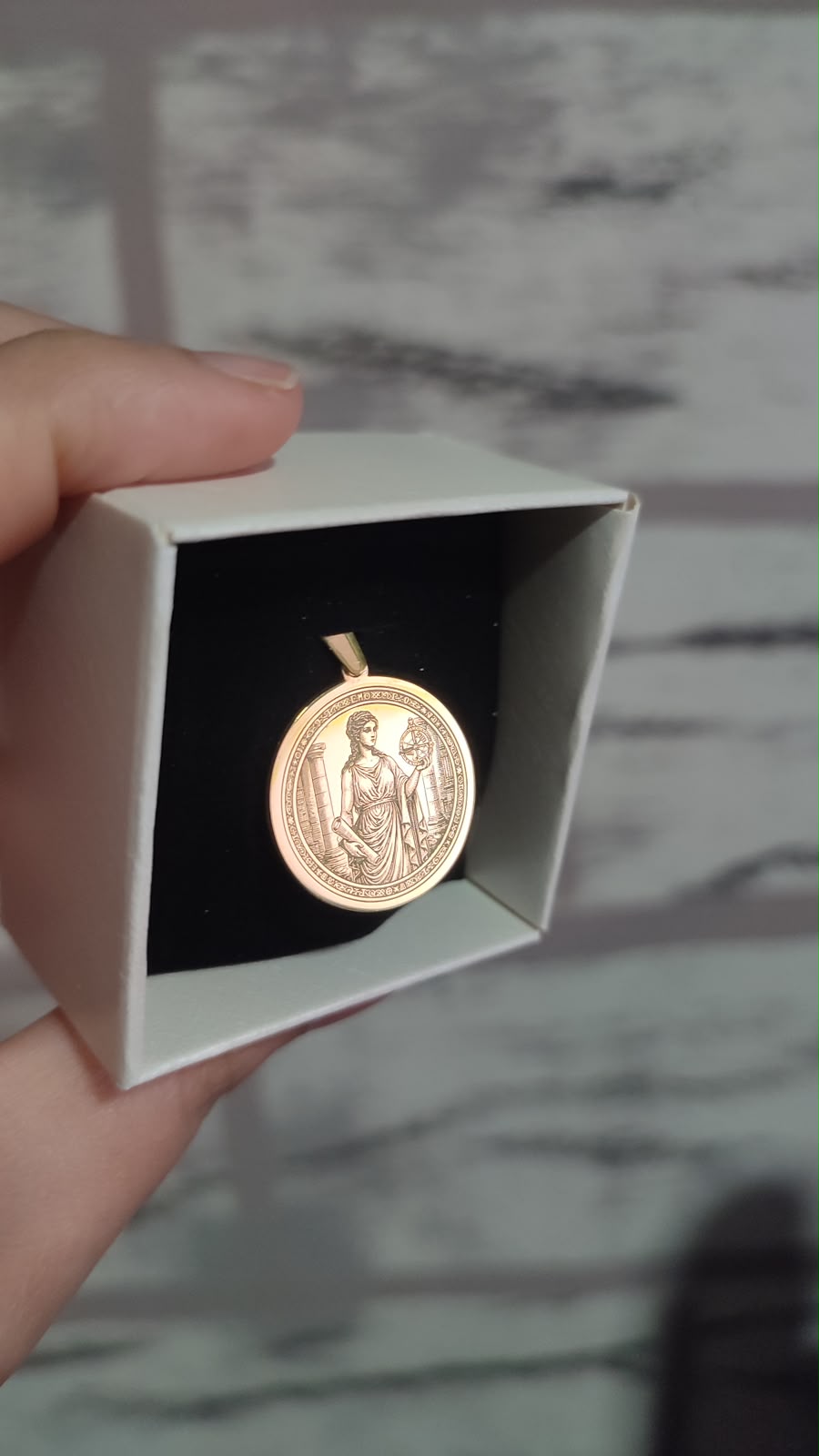 Goddess with astrolabe medallion in gold