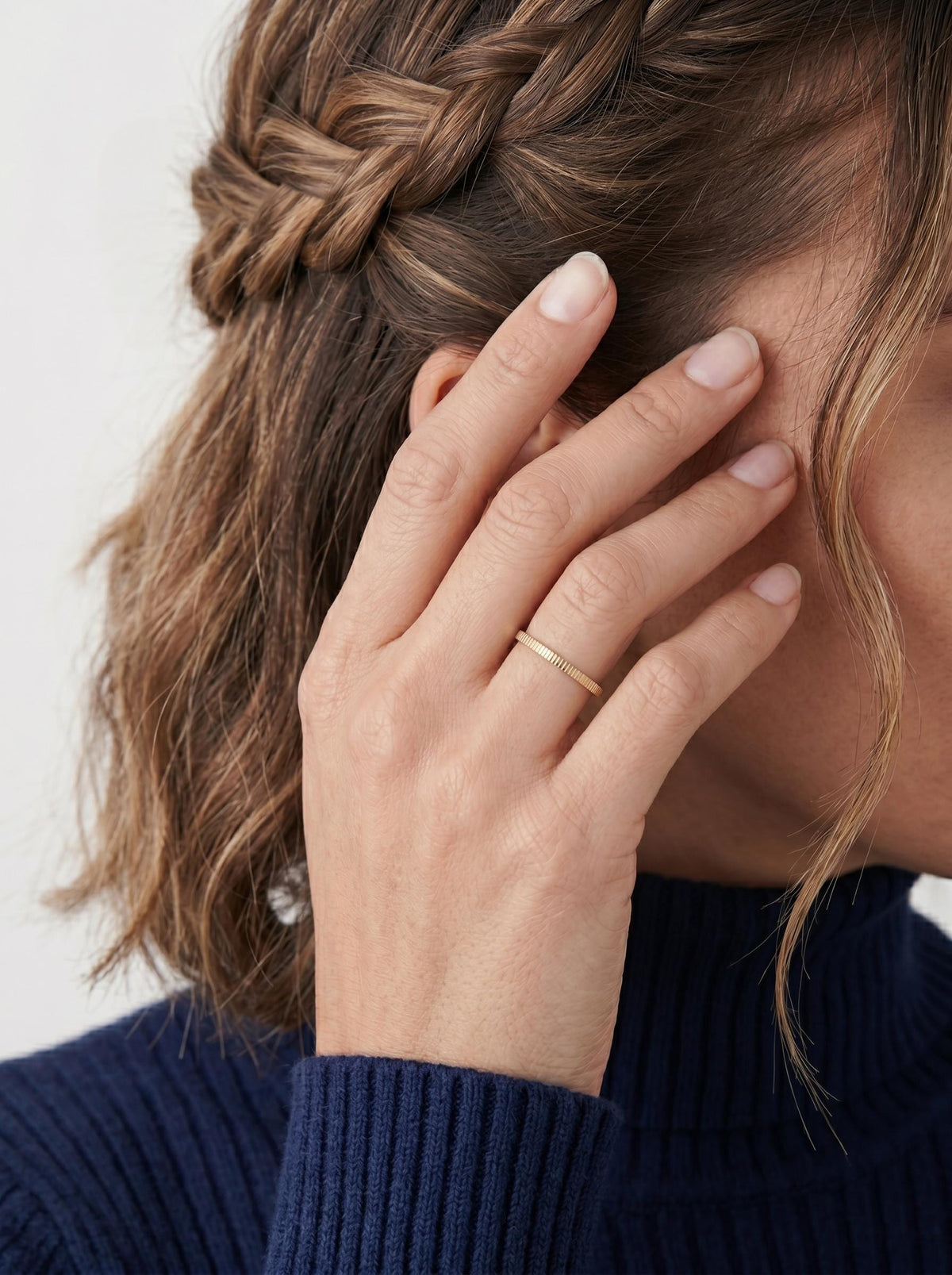 Model wearing the ribbed gold ring