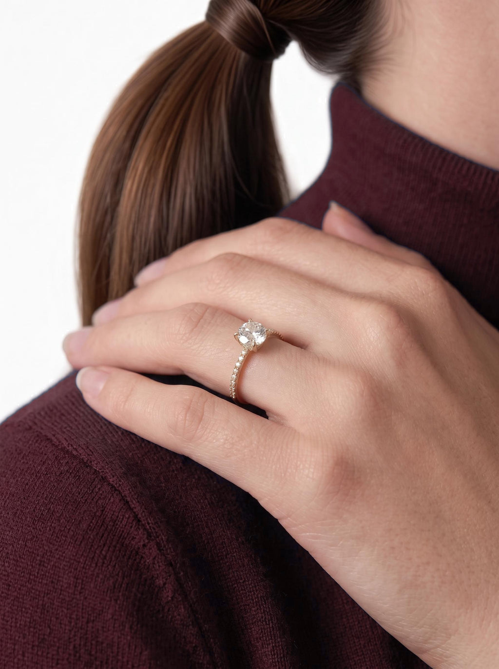 Diamond engagement ring worn on the hand at the shoulder