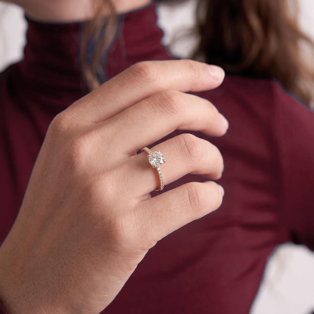 Round solitaire engagement ring worn on the hand